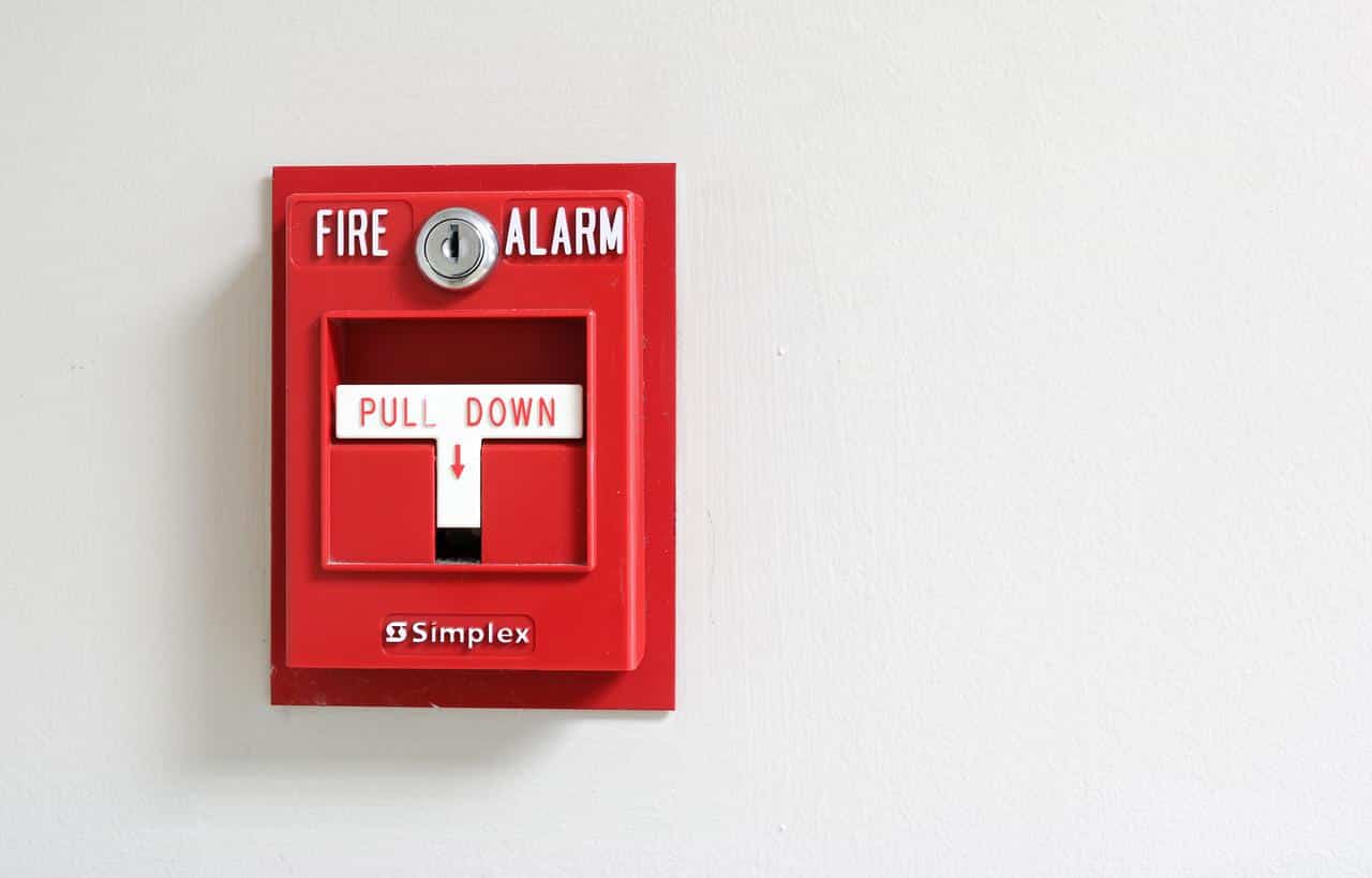 A red manual fire alarm.